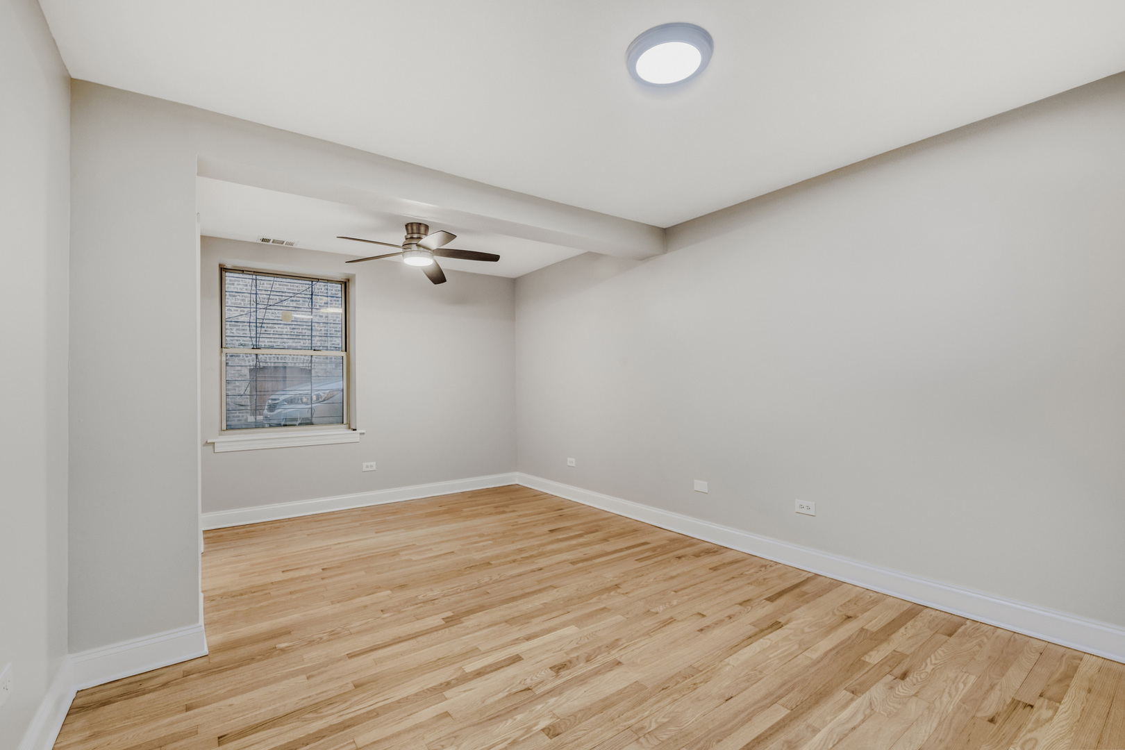 6450 North Bell Avenue, Unit G Chicago, IL 60645 - Photo 11 of 18 wooden floor in an empty room
