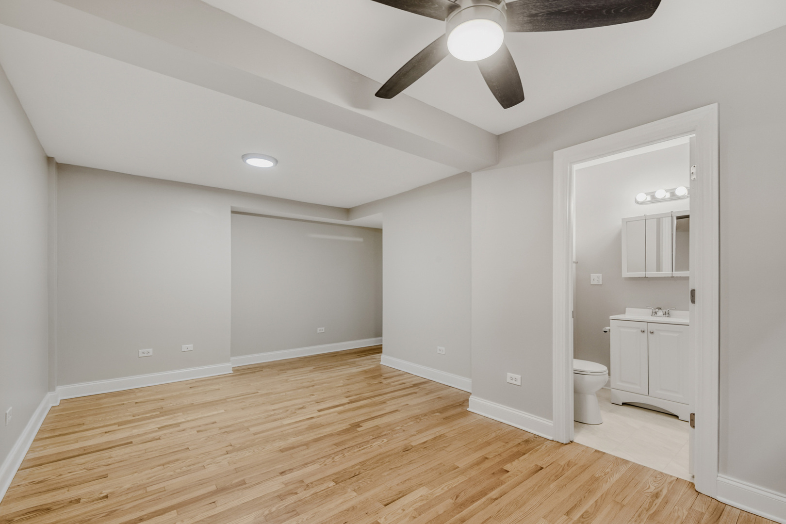 6450 North Bell Avenue, Unit G Chicago, IL 60645 - Photo 13 of 18 a view of an empty room and wooden floor