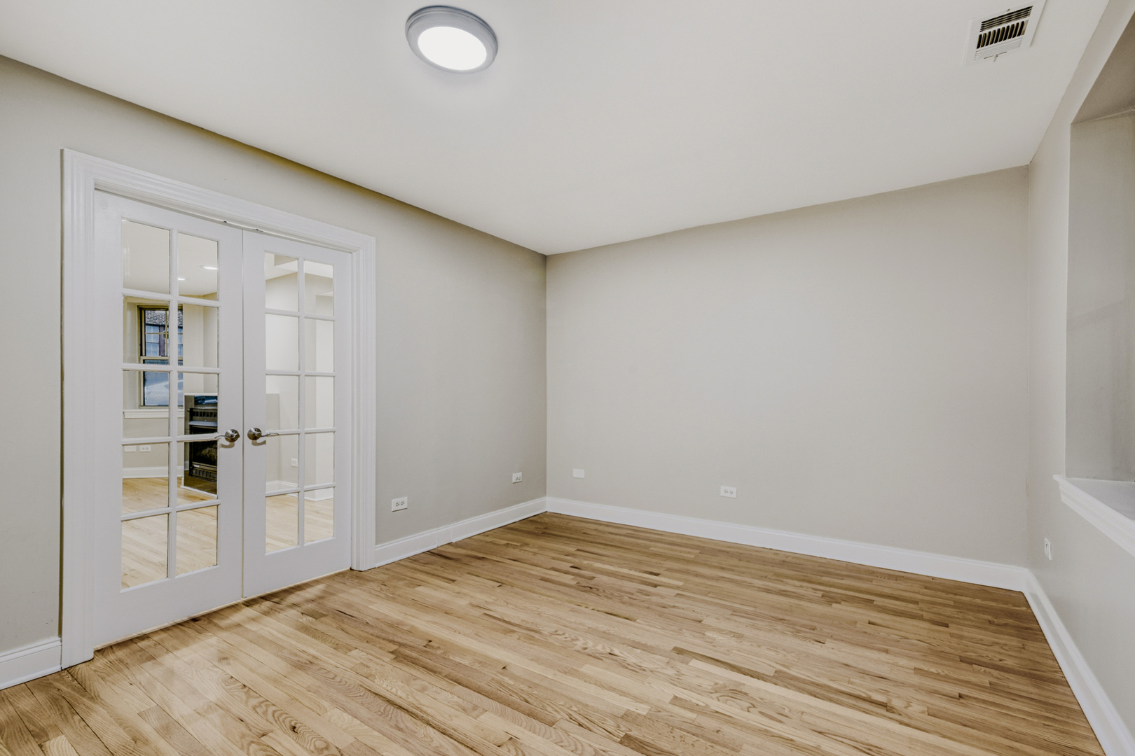 6450 North Bell Avenue, Unit G Chicago, IL 60645 - Photo 15 of 18 wooden floor in an empty room