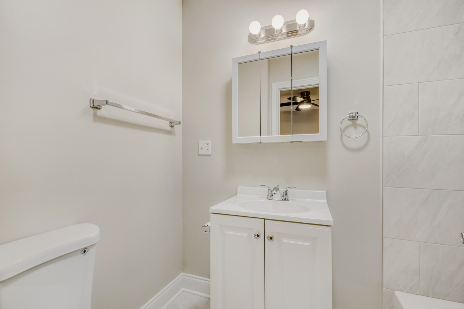 6450 North Bell Avenue, Unit G Chicago, IL 60645 - Photo 17 of 18 a bathroom with a sink and mirror