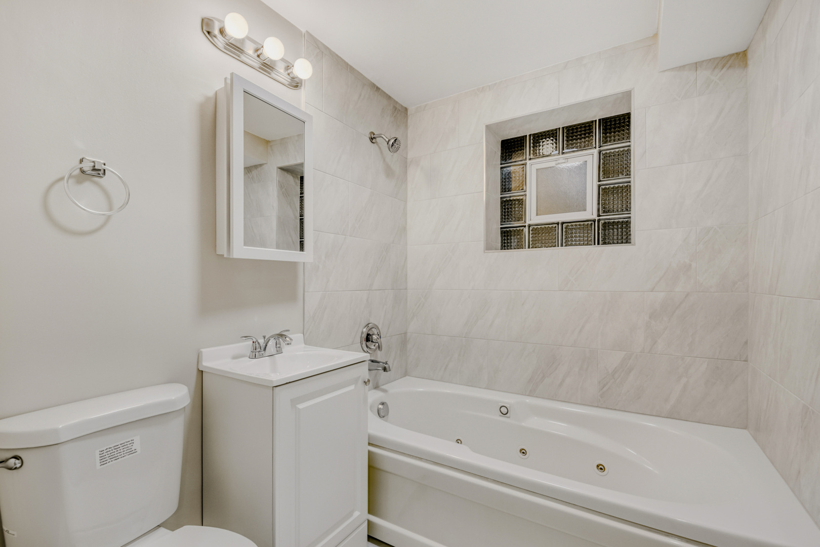 6450 North Bell Avenue, Unit G Chicago, IL 60645 - Photo 18 of 18 a bathroom with a bathtub a sink and a shower