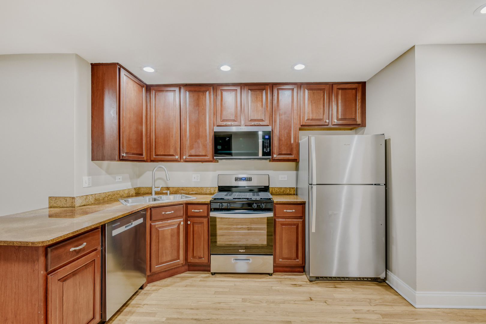 6450 North Bell Avenue, Unit G Chicago, IL 60645 - Photo 7 of 18 a kitchen with a sink appliances and cabinets