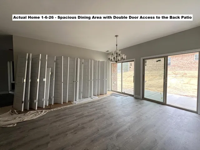 a view of a room with lots of appliances and wooden floor