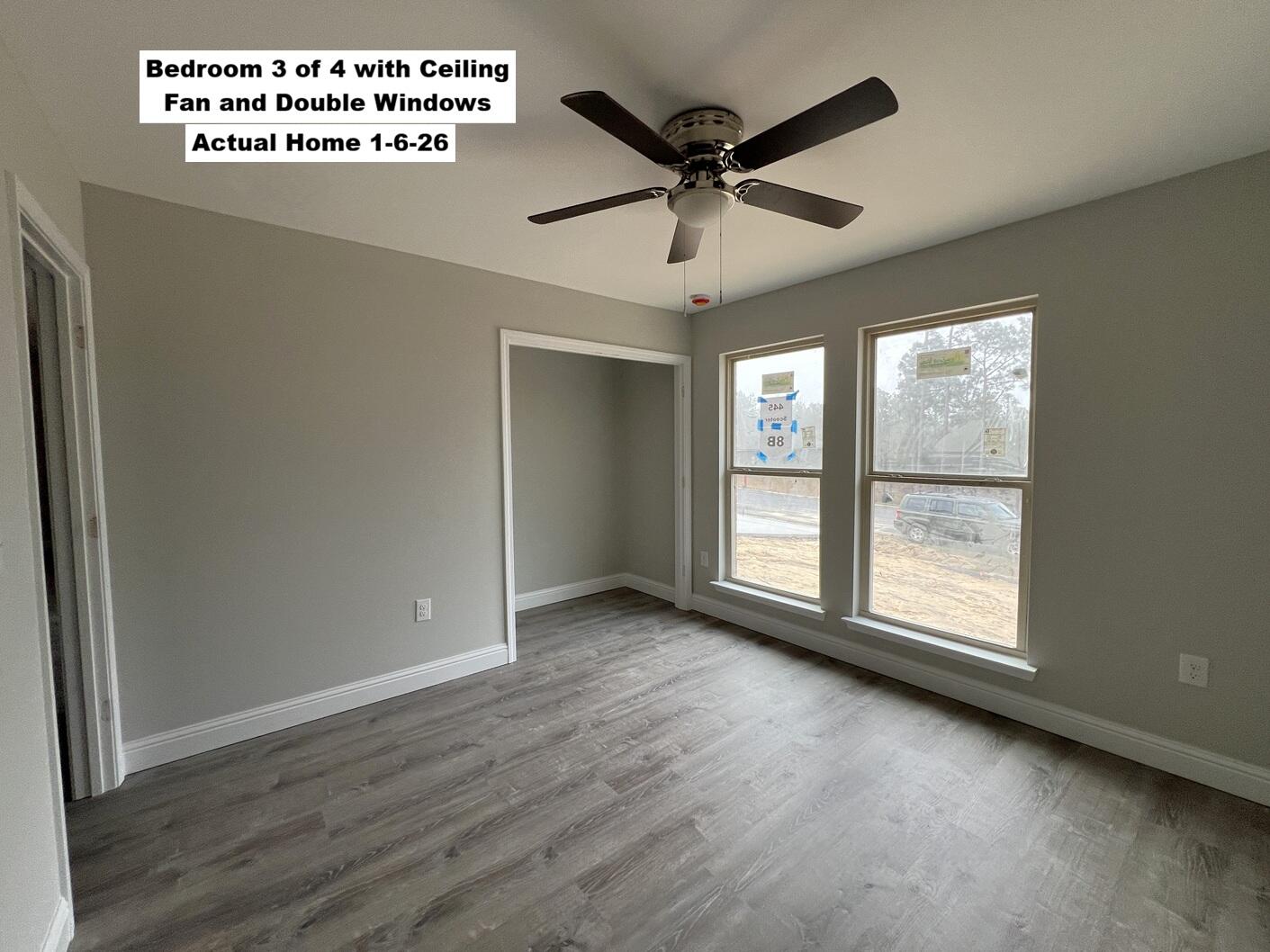 445 Scooter Cove Crestview, FL 32539 - Photo 7 of 12 a view of an empty room with wooden floor and a window
