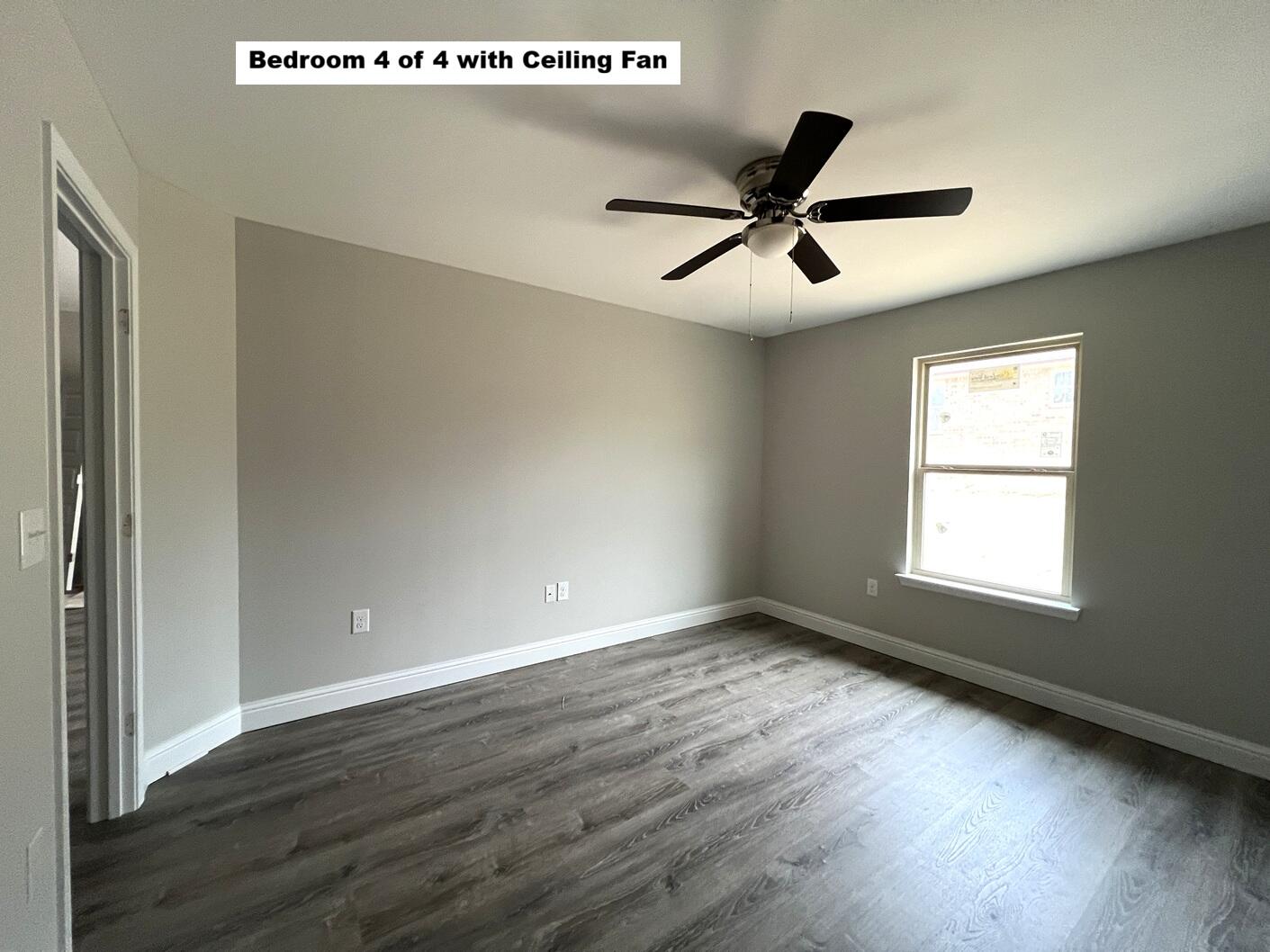 445 Scooter Cove Crestview, FL 32539 - Photo 8 of 12 a view of an empty room with wooden floor and a window