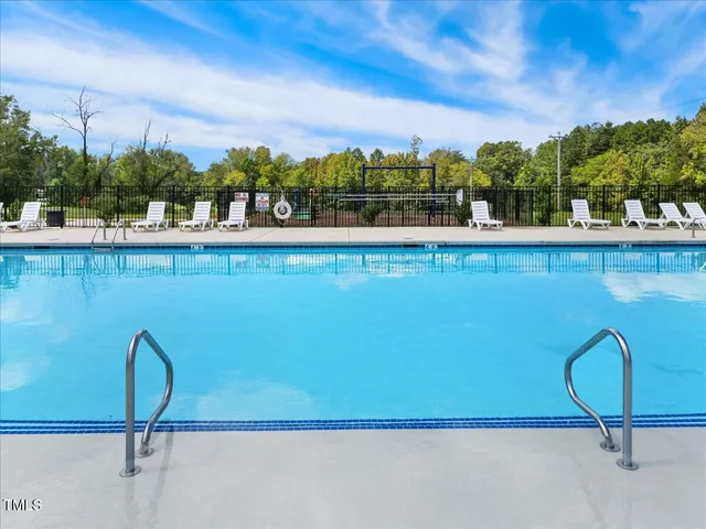a view of a swimming pool and an outdoor seating