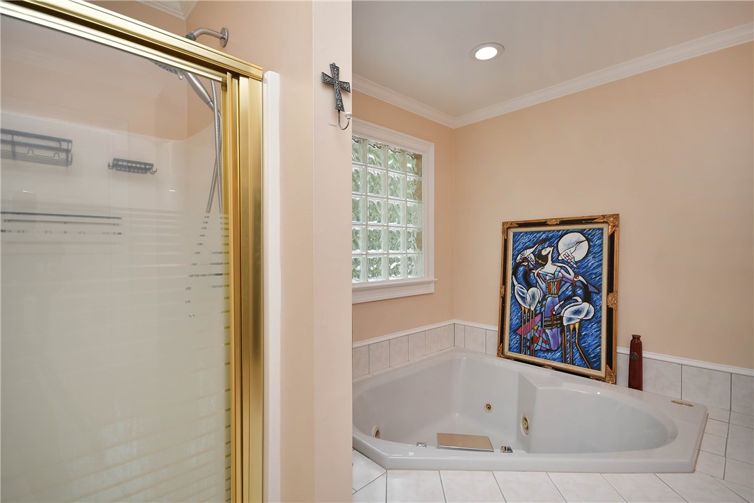 197 Deer Creek Road Easley, SC 29640 - Photo 23 of 50 Indulge in a tranquil retreat featuring a spacious soaking tub and a dedicated shower with a glass enclosure.