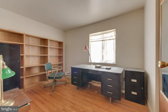 a view of a workspace with furniture and a window