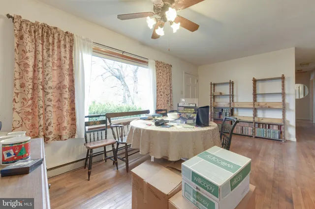 a living room with furniture and a large window with wooden floor