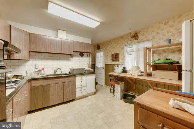 a kitchen with cabinets a sink and appliances