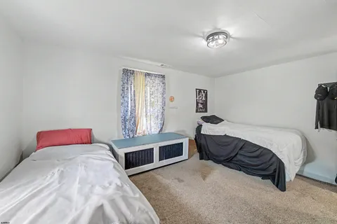 a spacious bedroom with a bed and a window
