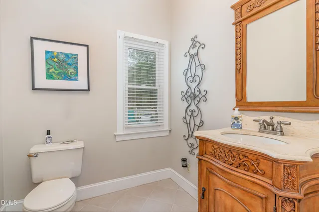 a bathroom with a sink a toilet and a window