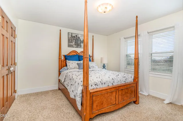 a bed room with a bed and a window