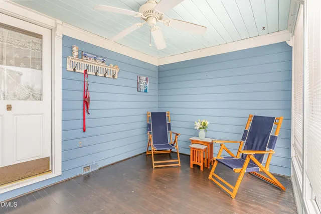a view of a room with chairs and table