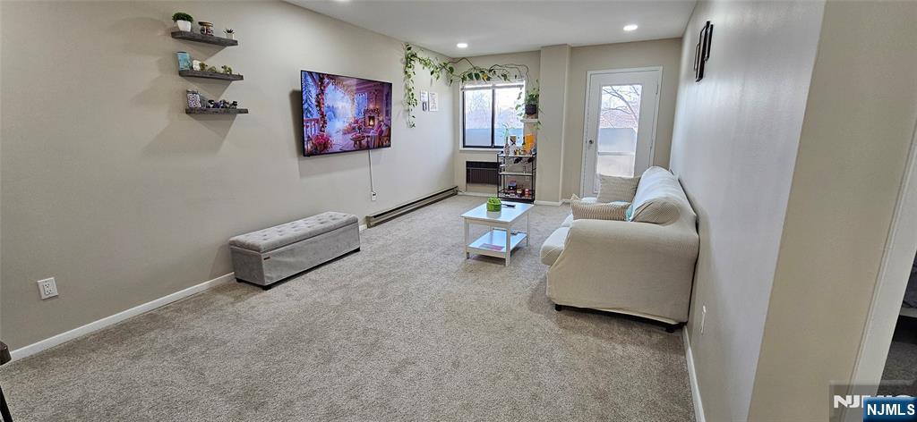 50 Euclid Avenue, Unit 3B Hackensack, NJ 07601 - Photo 11 of 16 a living room with furniture and a flat screen tv