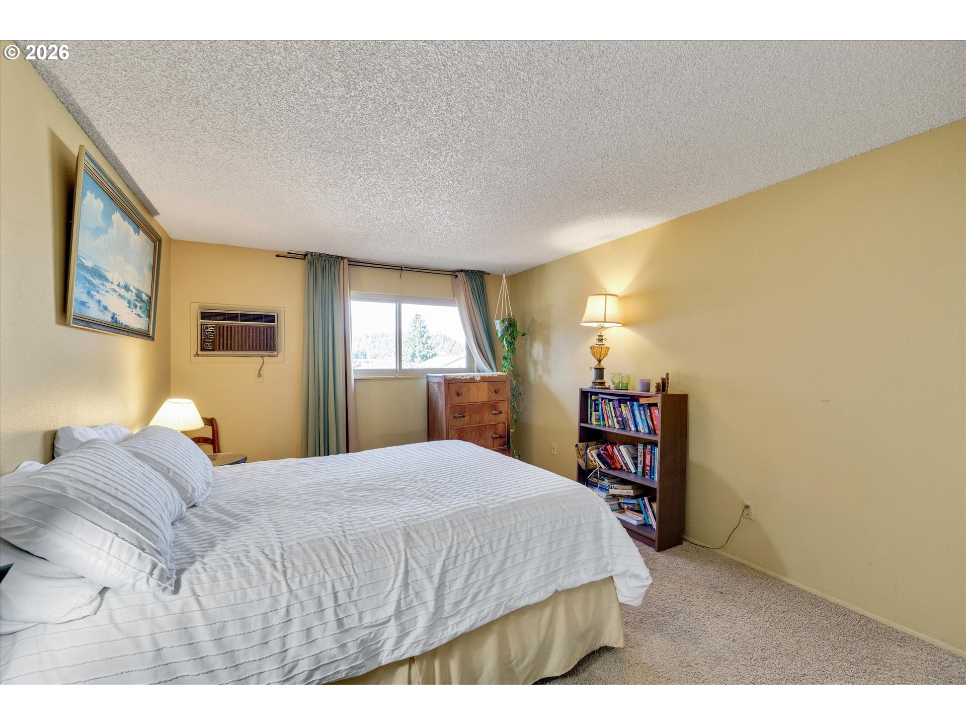 831 Northeast 90th Avenue Portland, OR 97220 - Photo 16 of 25 a bedroom with a bed and a bookshelf with wooden floor
