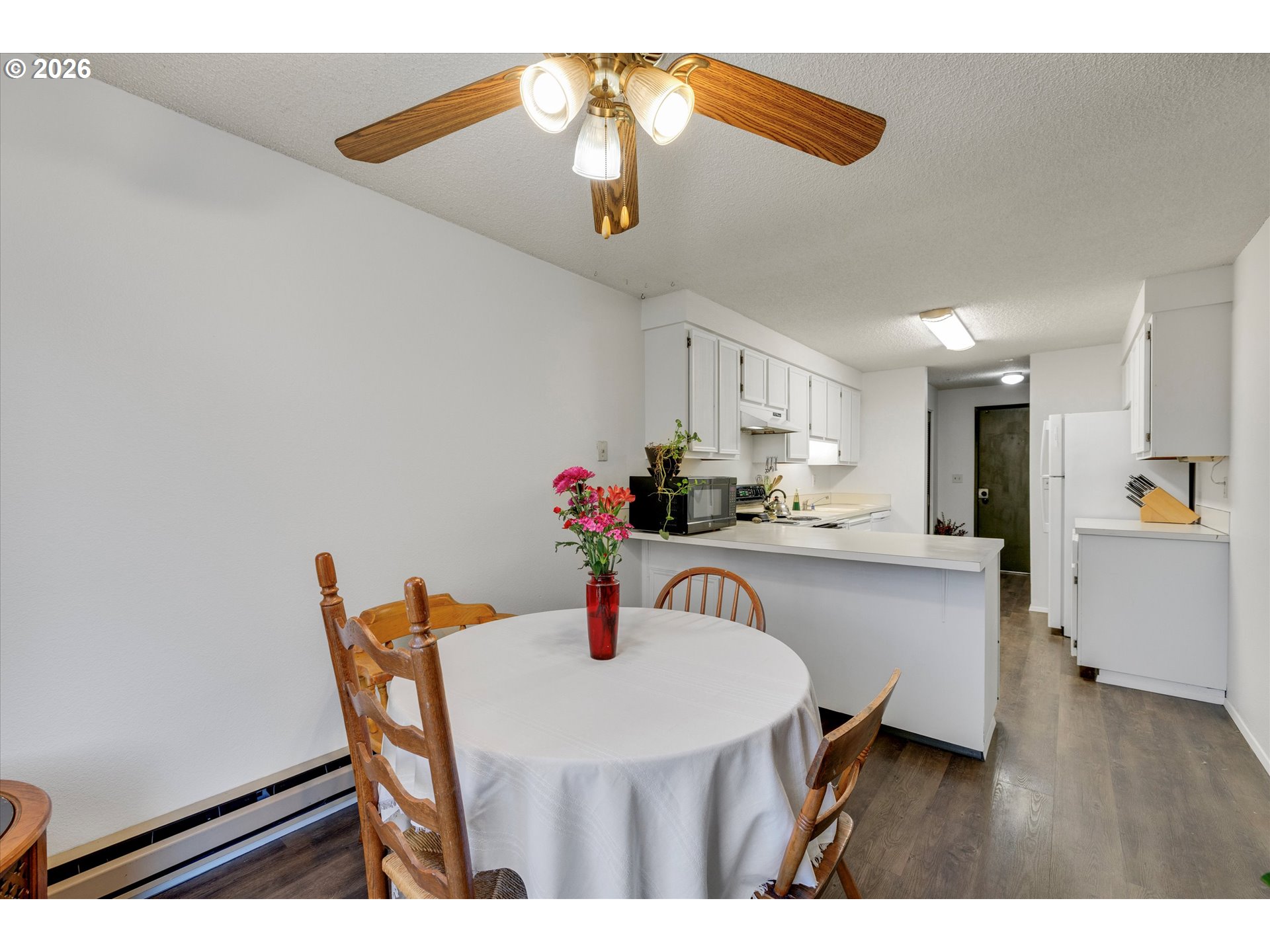 831 Northeast 90th Avenue Portland, OR 97220 - Photo 7 of 25 a kitchen with a table and chairs