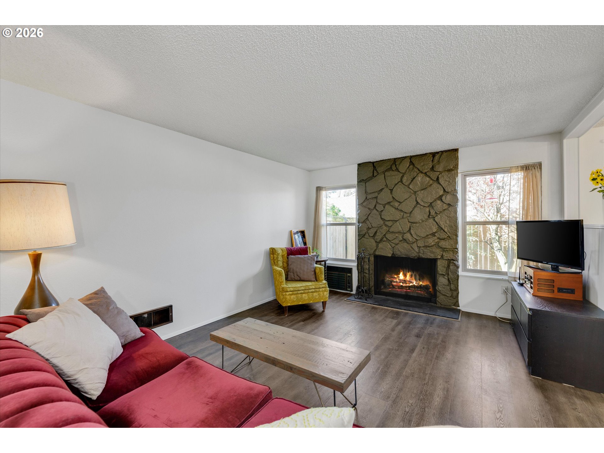 831 Northeast 90th Avenue Portland, OR 97220 - Photo 8 of 25 a living room with furniture and a fireplace