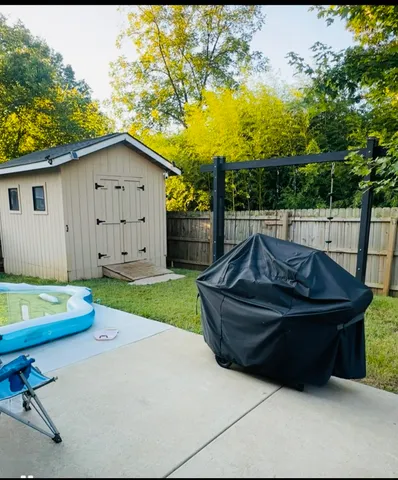 a view of a backyard with plants and a patio