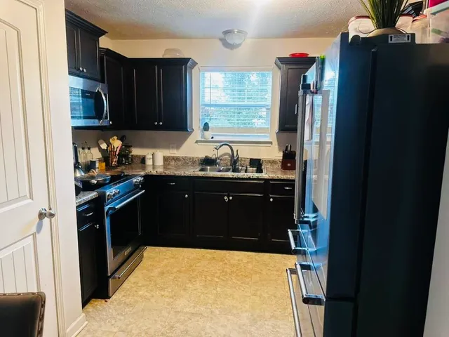 a kitchen with a sink and a refrigerator