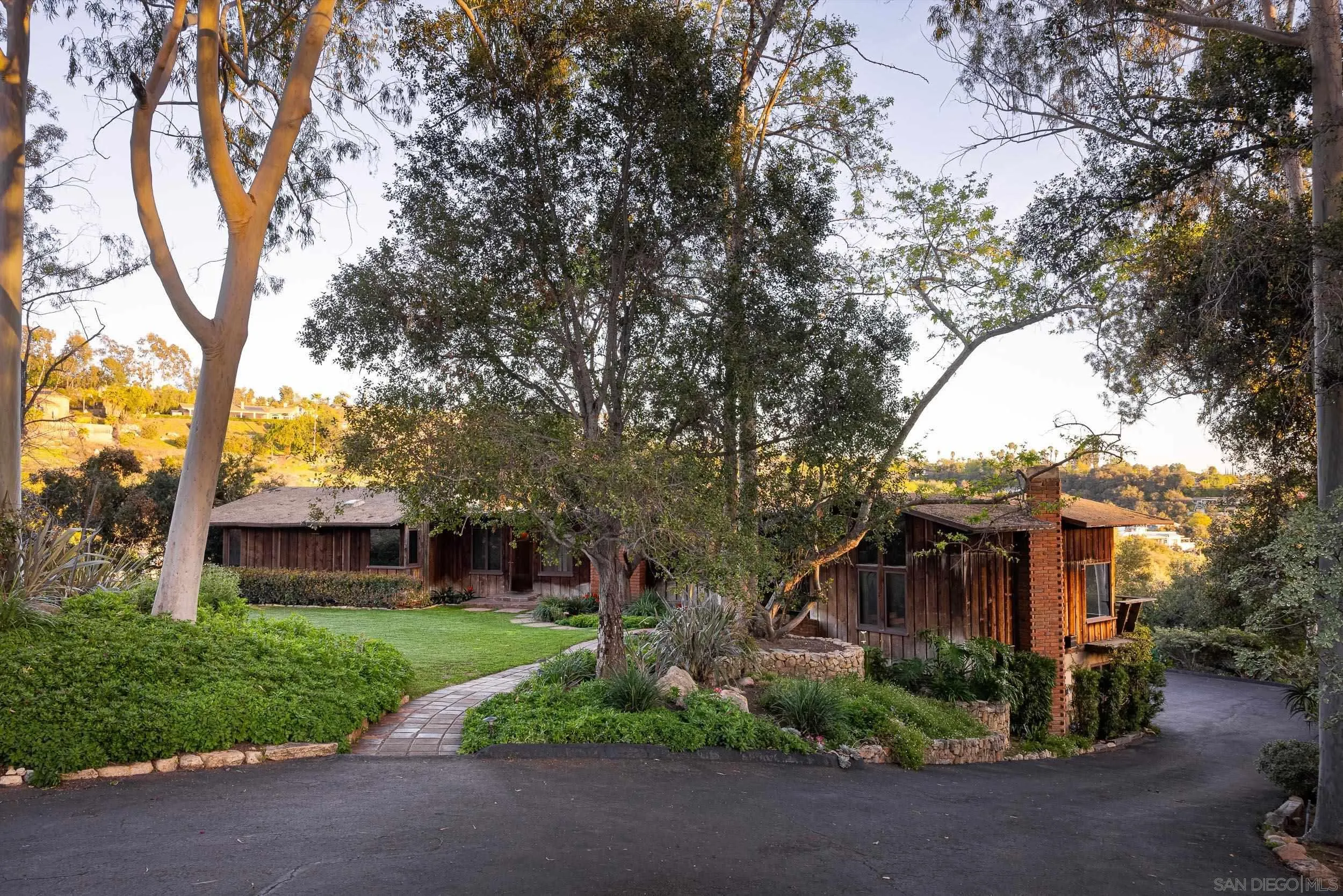 2411 Canyon Road Escondido, CA 92025 - Photo 6 of 41 a front view of a house with a yard and a garden