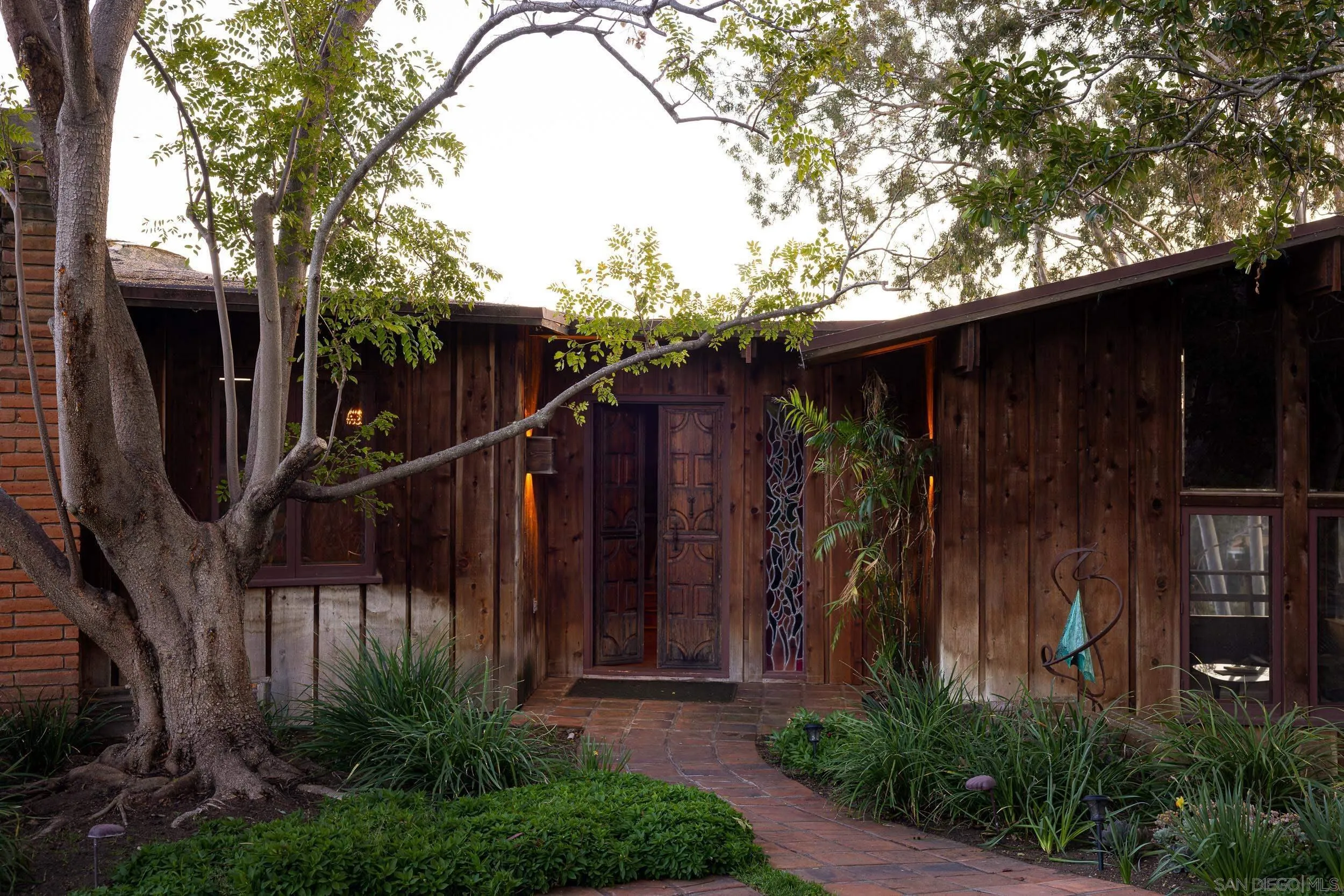2411 Canyon Road Escondido, CA 92025 - Photo 9 of 41 a view of a house with a small yard and large tree