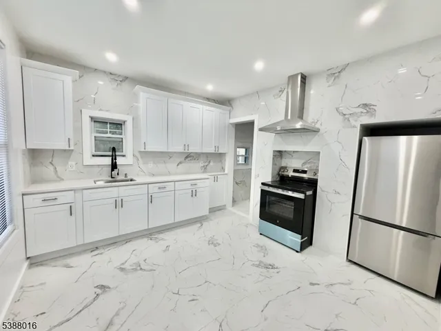 a kitchen with white cabinets and white appliances