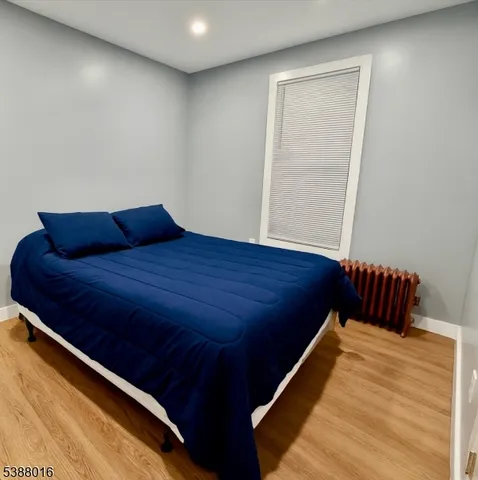 a bed sitting in a bedroom next to a window