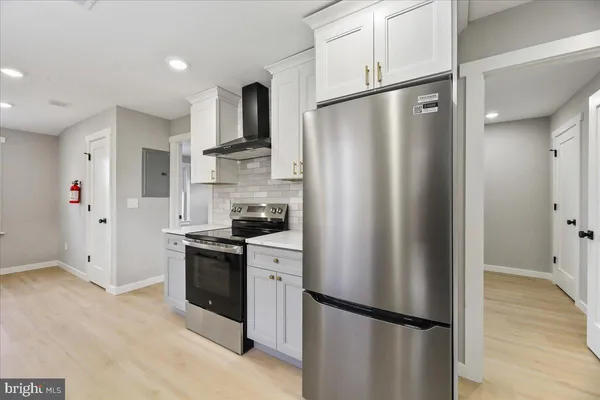 a kitchen with stainless steel appliances a refrigerator and cabinets