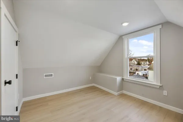 an empty room with windows and closet