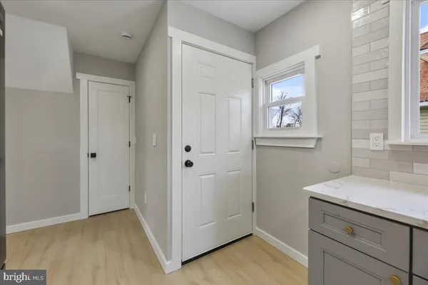 a view of storage and utility room with closet