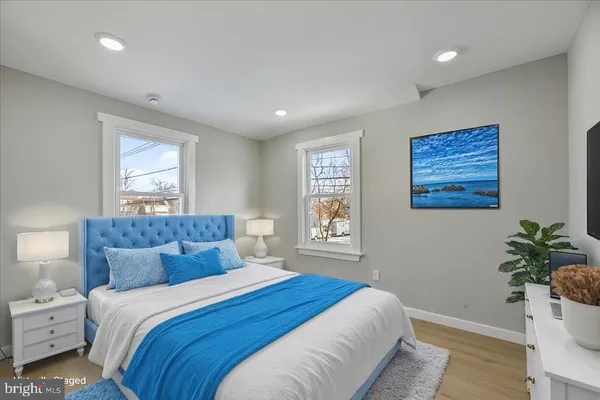 a bedroom with a large bed and a potted plant