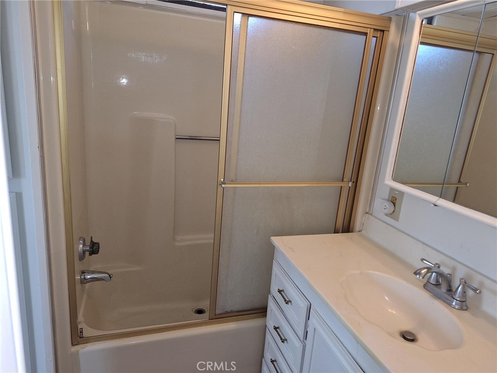 860 Birch Drive San Jacinto, CA 92583 - Photo 3 of 16 a bathroom with a sink and a mirror