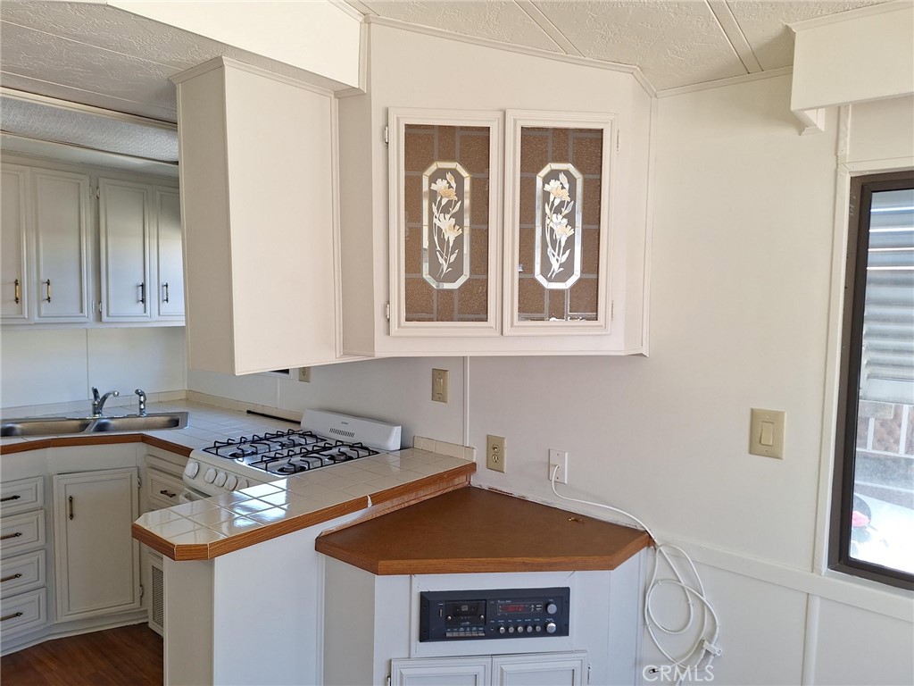 860 Birch Drive San Jacinto, CA 92583 - Photo 7 of 16 a kitchen with stainless steel appliances granite countertop a stove and a microwave