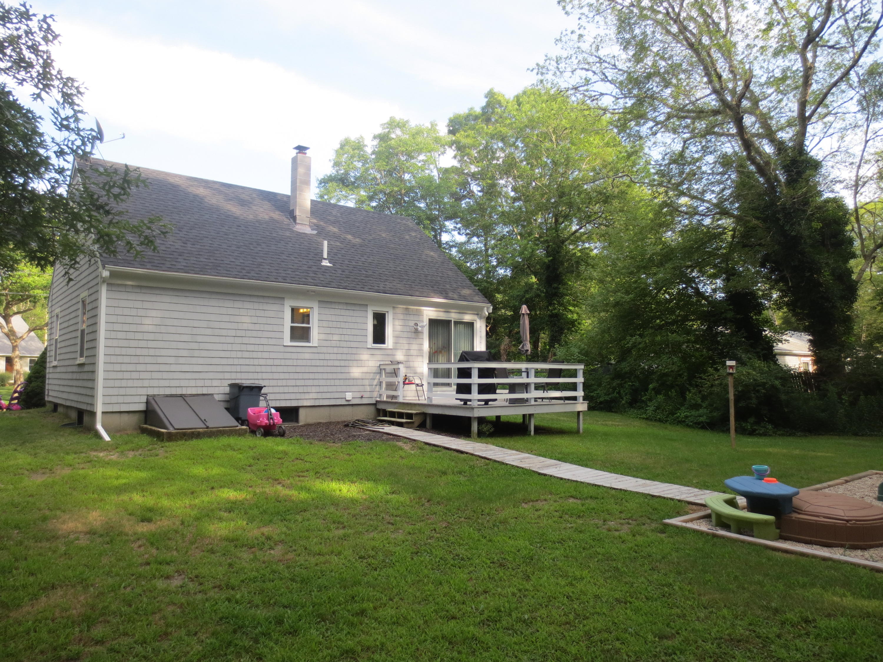 35 Stage Coach Road Centerville, MA 02632 - Photo 3 of 29 a view of a house with backyard sitting area and garden