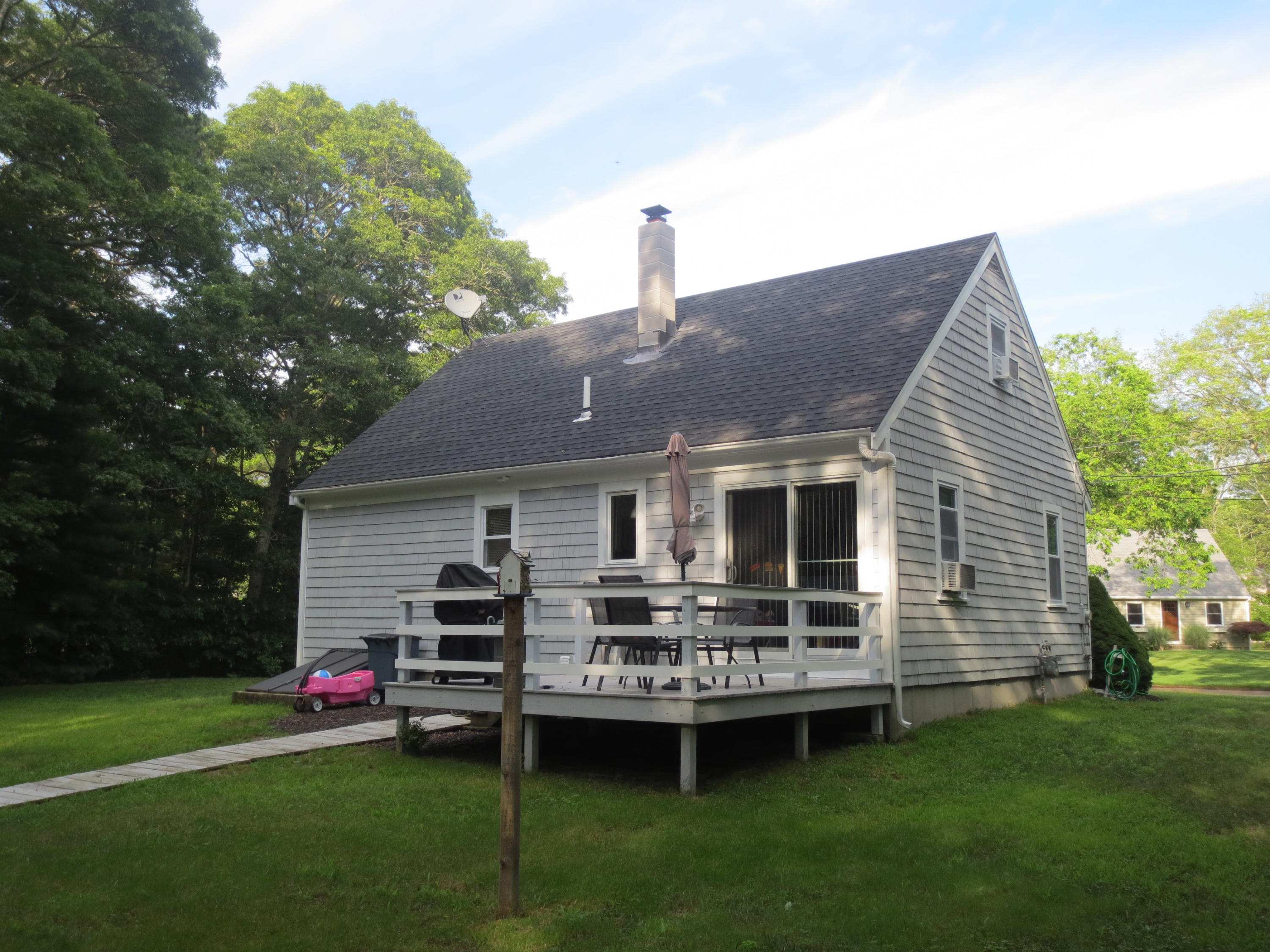 35 Stage Coach Road Centerville, MA 02632 - Photo 4 of 29 a front view of a house with a garden and deck
