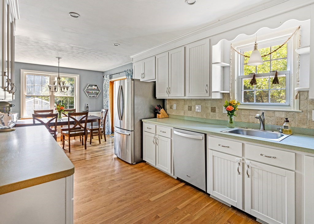 14 Hoover Road Northborough, MA 01532 - Photo 8 of 30 a kitchen with white cabinets and wooden floors