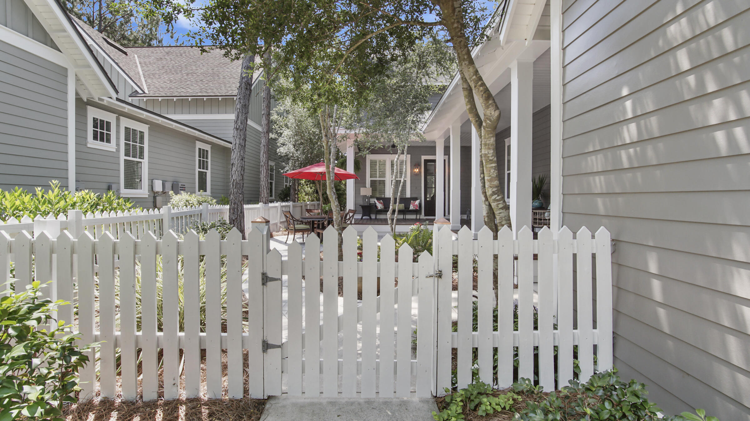 247 Artesian Way Watersound, FL 32461 - Photo 3 of 36 a front view of white house with a small yard