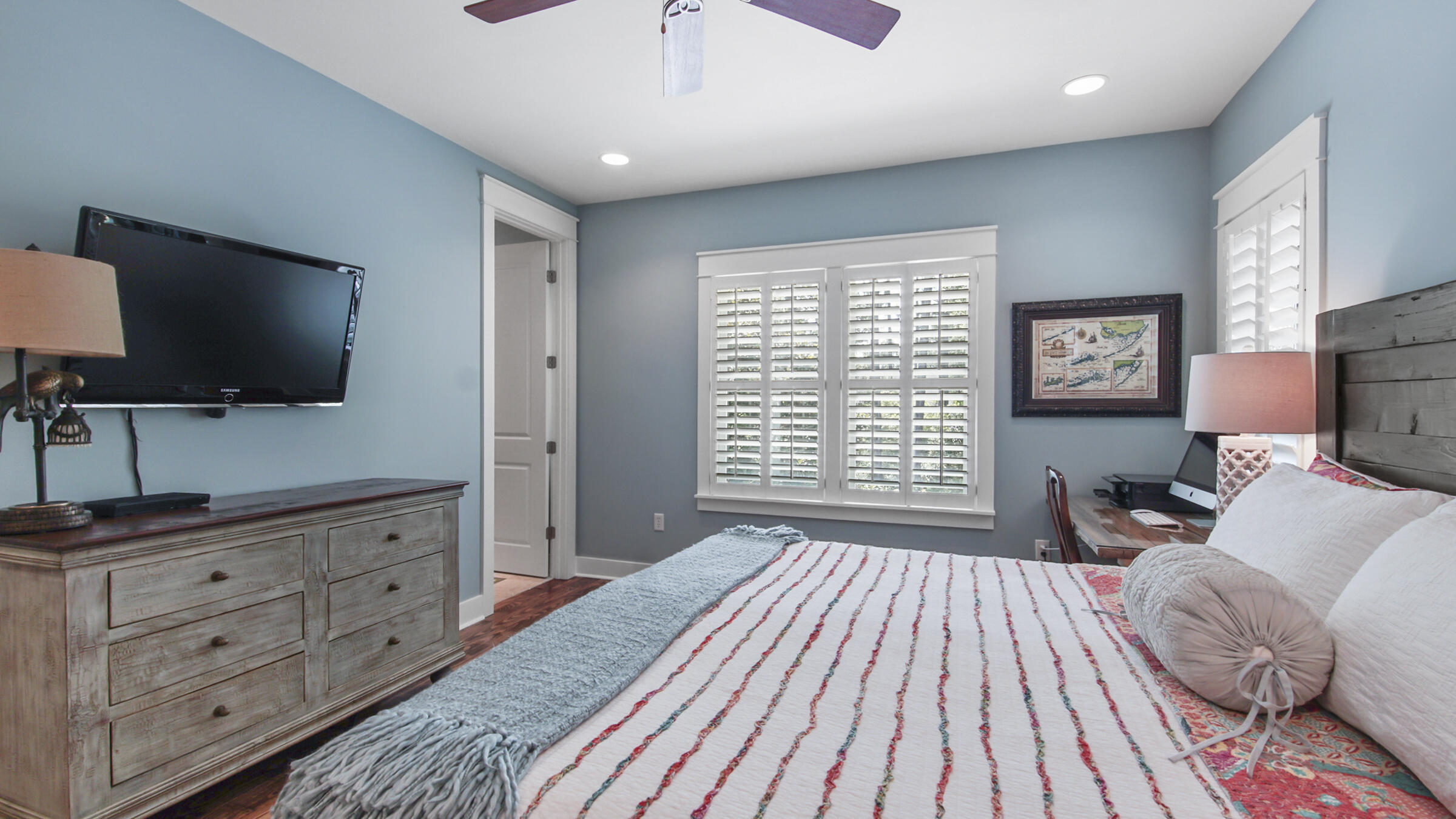 247 Artesian Way Watersound, FL 32461 - Photo 27 of 36 a spacious bedroom with a bed and a flat screen tv
