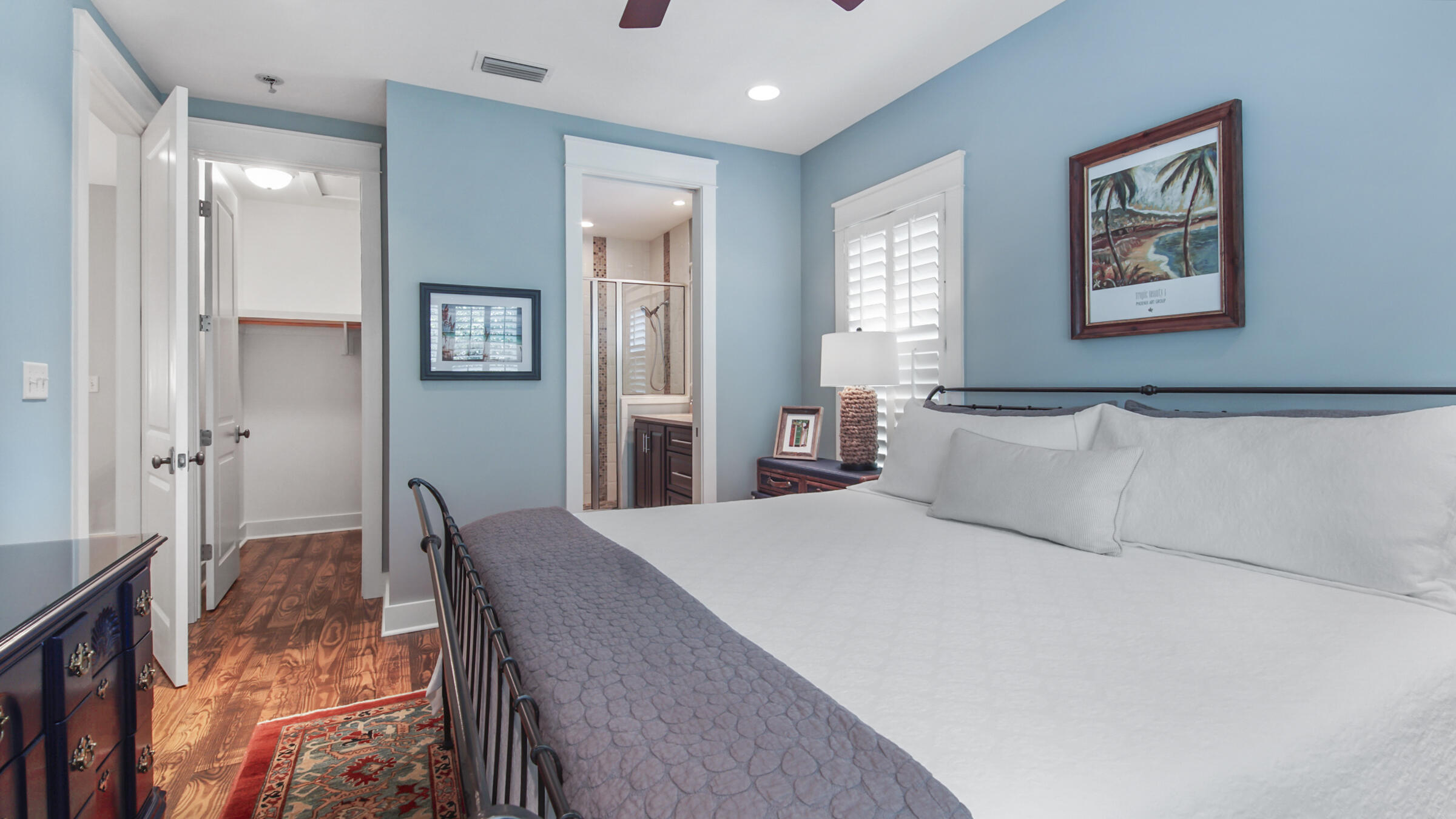 247 Artesian Way Watersound, FL 32461 - Photo 32 of 36 a bedroom with a large bed and a chandelier