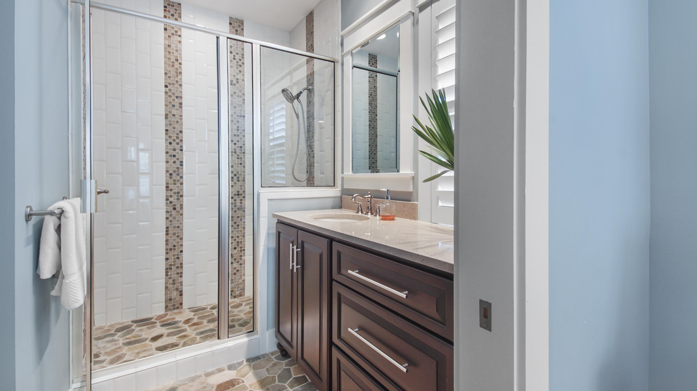 247 Artesian Way Watersound, FL 32461 - Photo 34 of 36 a bathroom with a mirror a sink and a shower