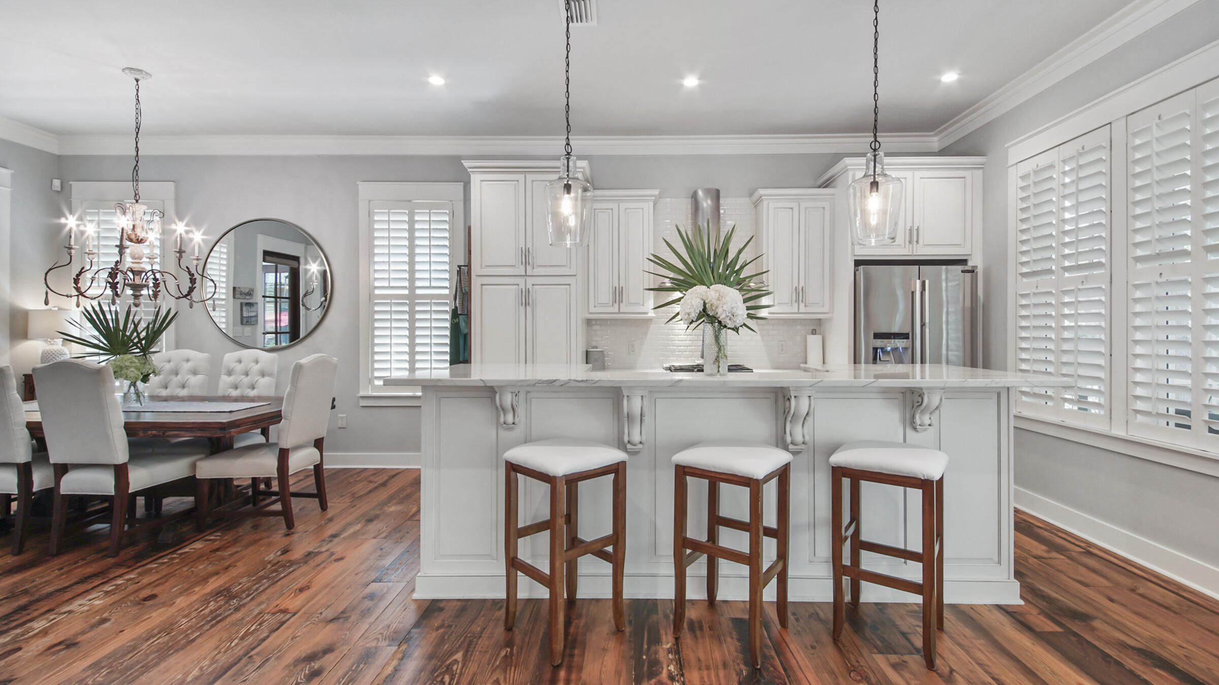247 Artesian Way Watersound, FL 32461 - Photo 8 of 36 a kitchen with granite countertop a table chairs stove a refrigerator and cabinets
