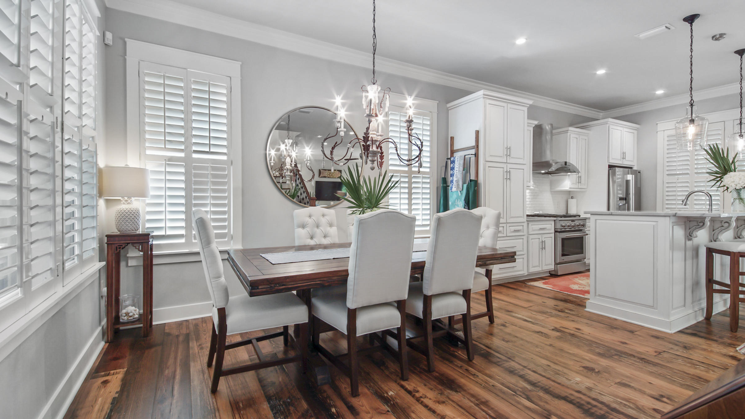 247 Artesian Way Watersound, FL 32461 - Photo 10 of 36 a dining room with furniture a chandelier and wooden floor