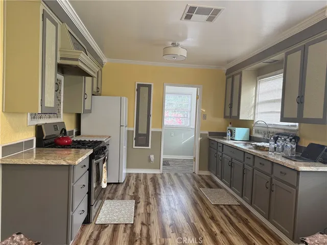 a kitchen with a sink stove and refrigerator