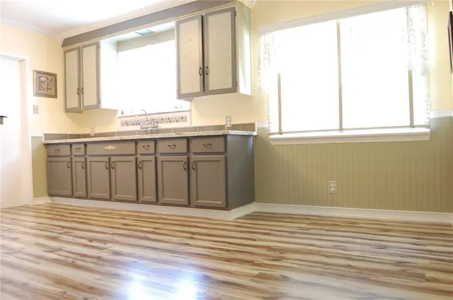 a view of a kitchen with granite countertop cabinets and a large window