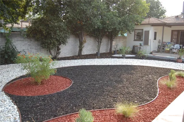 a view of a backyard with plants and lake