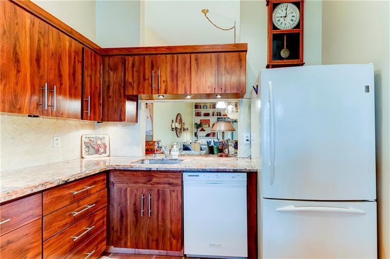 3342 Carambola Circle South Coconut Creek, FL 33066 - Photo 4 of 17 a kitchen with stainless steel appliances granite countertop a refrigerator and a white cabinets