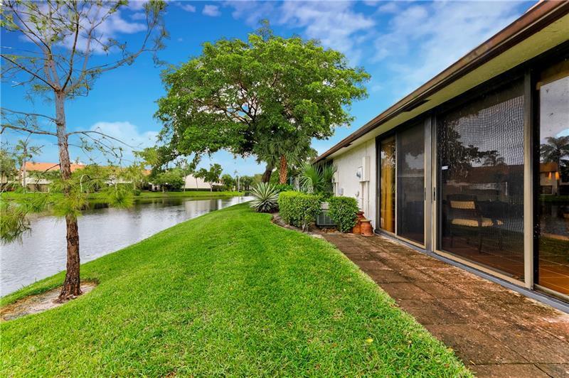 3342 Carambola Circle South Coconut Creek, FL 33066 - Photo 6 of 17 a backyard of a house with lots of green space and lake view