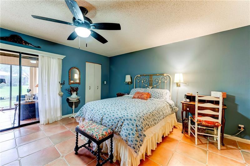 3342 Carambola Circle South Coconut Creek, FL 33066 - Photo 9 of 17 a bed room with a bed and a chandelier