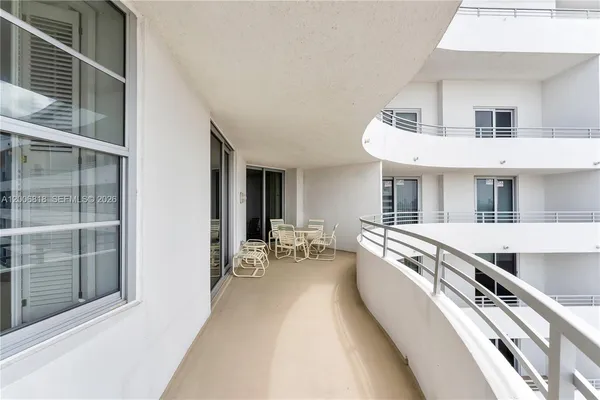 a view of a patio with table and chairs and wooden floor